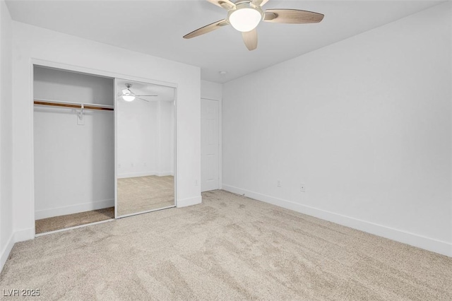 unfurnished bedroom with carpet flooring, a closet, baseboards, and a ceiling fan
