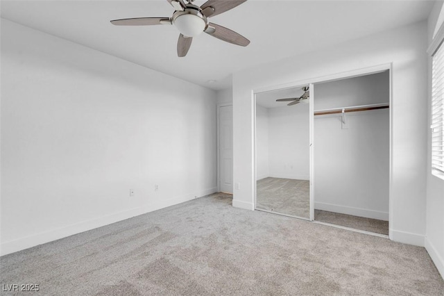 unfurnished bedroom featuring carpet, a closet, a ceiling fan, and baseboards