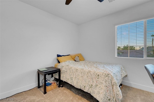 carpeted bedroom featuring baseboards and ceiling fan