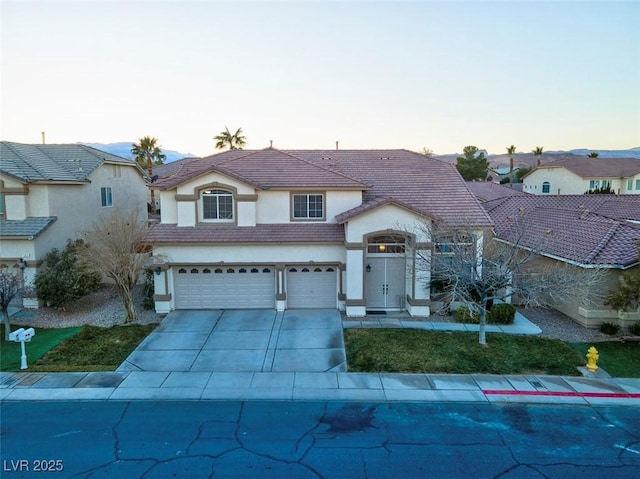 view of front of home featuring stucco siding, concrete driveway, a garage, and a tile roof