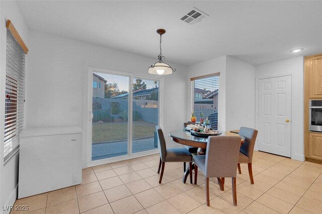 dining space featuring light tile patterned floors and recessed lighting