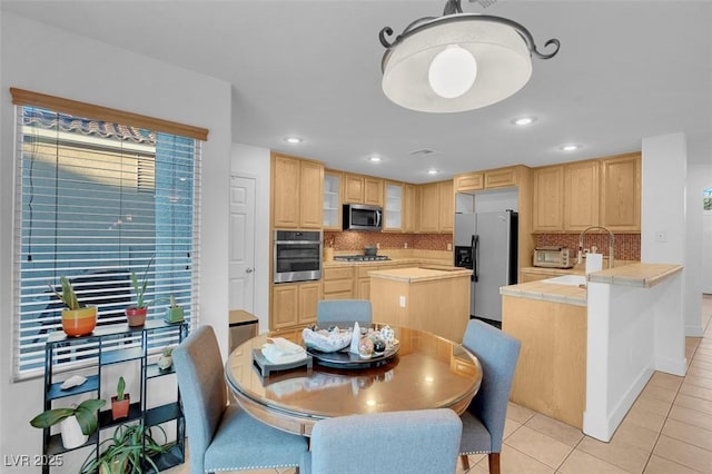 dining space with light tile patterned floors, recessed lighting, and baseboards