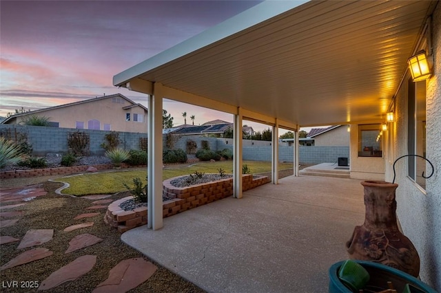 view of patio terrace at dusk