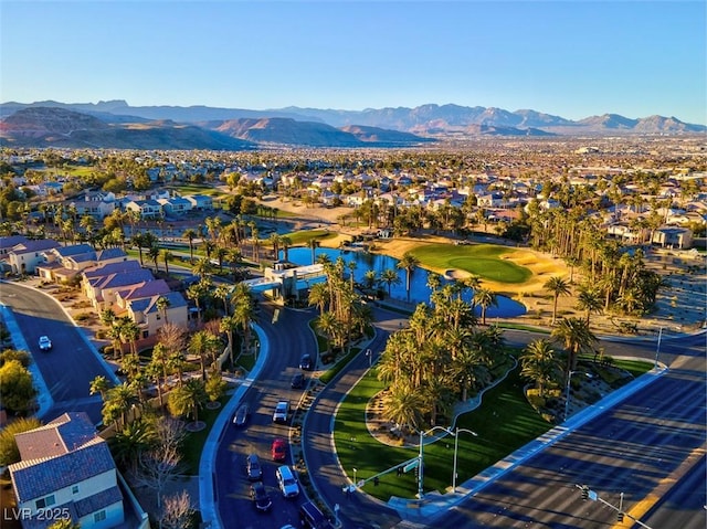 aerial view of residential area with a golf club and a water and mountain view