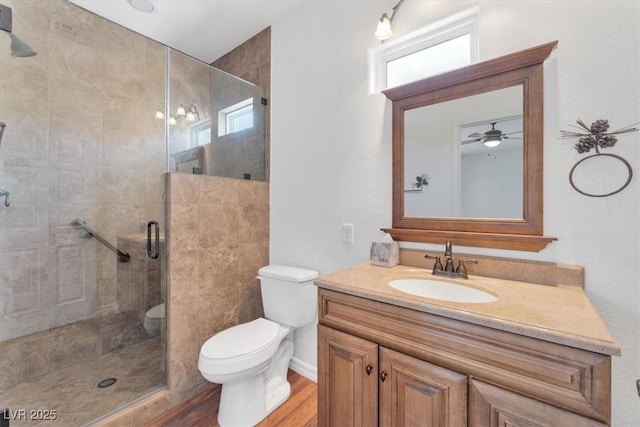 bathroom with hardwood / wood-style flooring, vanity, an enclosed shower, and toilet