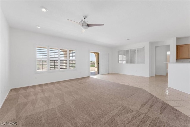 tiled spare room with ceiling fan