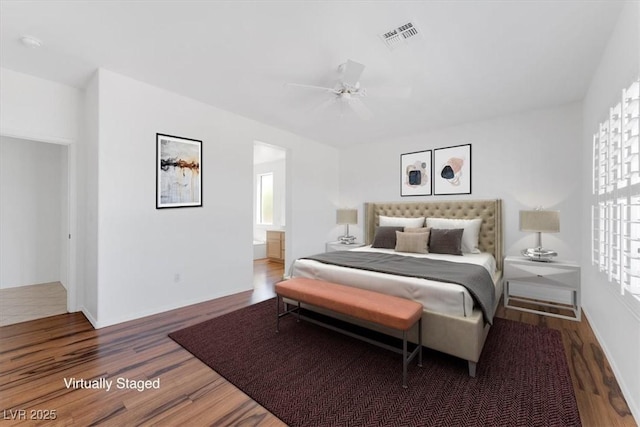 bedroom featuring ceiling fan, connected bathroom, and dark hardwood / wood-style flooring