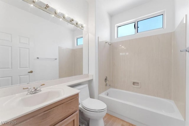 full bathroom featuring washtub / shower combination, vanity, toilet, and hardwood / wood-style floors