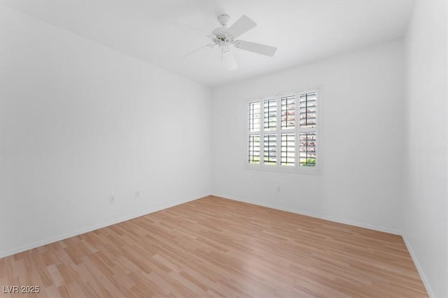 spare room featuring ceiling fan and light wood-type flooring