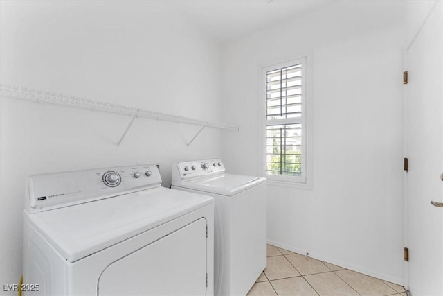 laundry area with light tile patterned floors and washer and clothes dryer