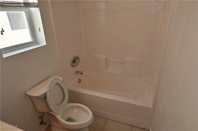 bathroom with tile patterned flooring, shower / washtub combination, and toilet