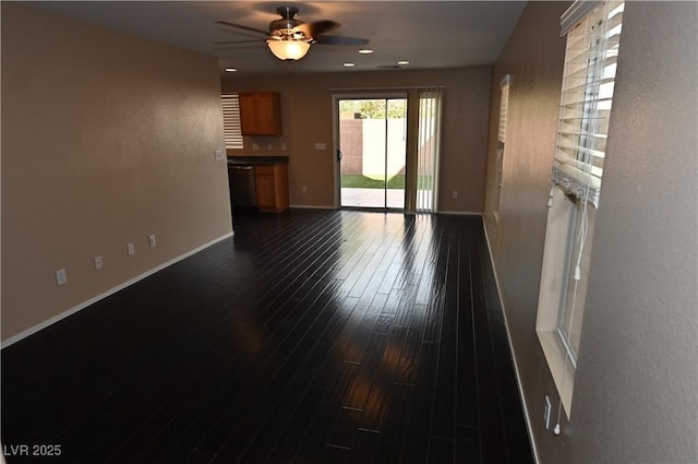 unfurnished living room featuring dark hardwood / wood-style floors and ceiling fan