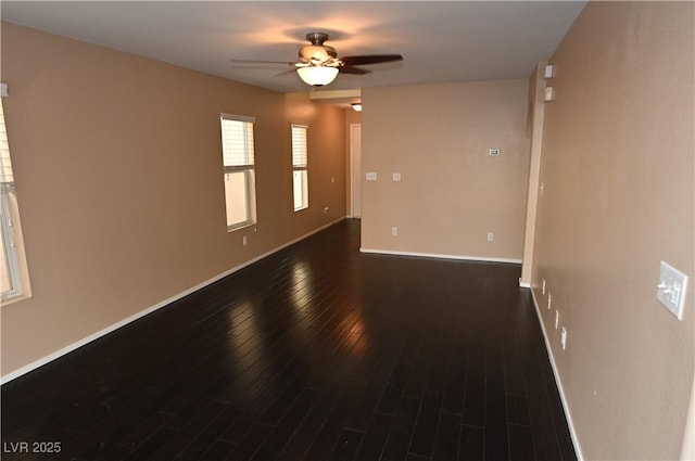 spare room with ceiling fan and dark hardwood / wood-style floors