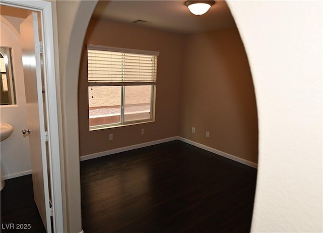 empty room featuring dark wood-type flooring