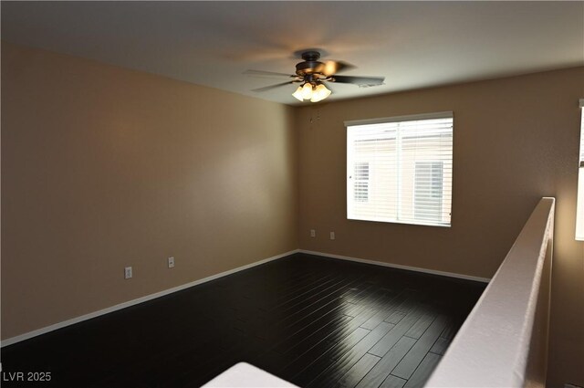 unfurnished room with ceiling fan and dark hardwood / wood-style floors