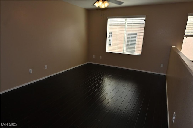 unfurnished room with a healthy amount of sunlight, dark wood-type flooring, and ceiling fan