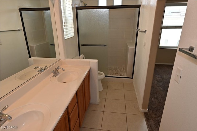 bathroom with vanity, a shower with door, tile patterned floors, and toilet