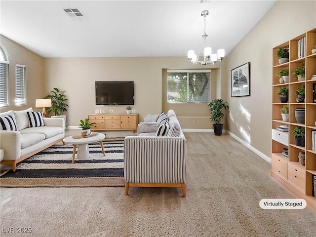 living room with a healthy amount of sunlight, light carpet, and a notable chandelier