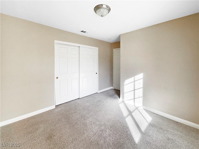 unfurnished bedroom featuring carpet floors and a closet