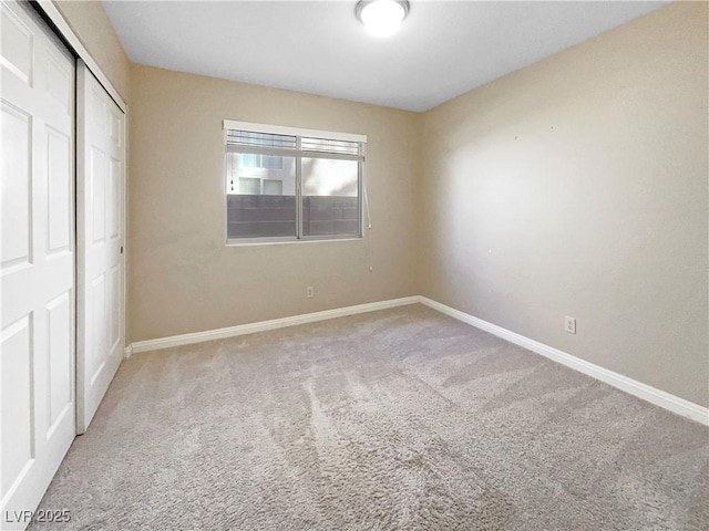 unfurnished bedroom featuring carpet floors and a closet