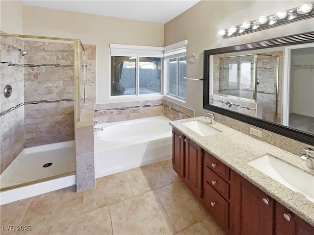 bathroom featuring tile patterned floors, vanity, and separate shower and tub