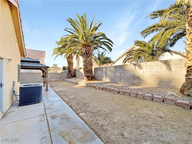 view of yard featuring a gazebo, central AC, and a patio