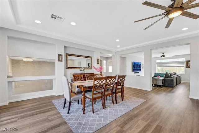 dining room with ceiling fan and wood-type flooring