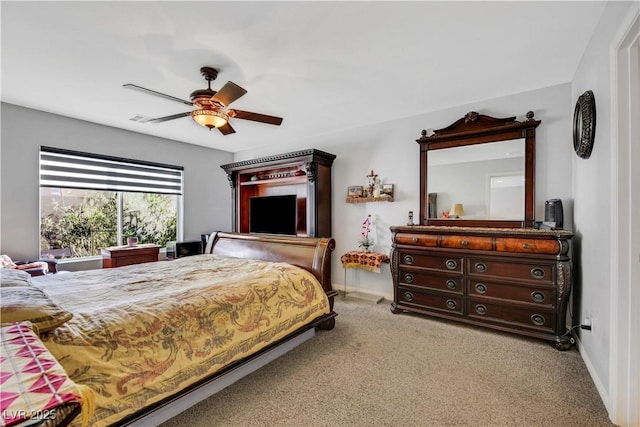 bedroom featuring light carpet and ceiling fan