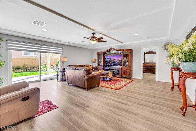 living room with light hardwood / wood-style floors and ceiling fan