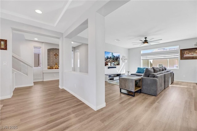 living room with ceiling fan and light hardwood / wood-style floors