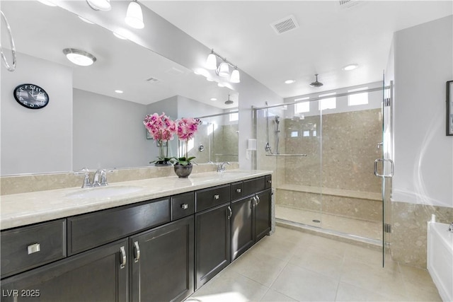 bathroom featuring vanity, tile patterned floors, and a shower with shower door