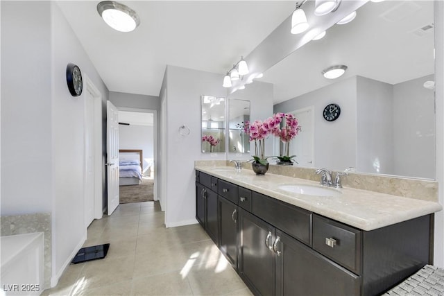 bathroom with vanity, a bath, and tile patterned flooring