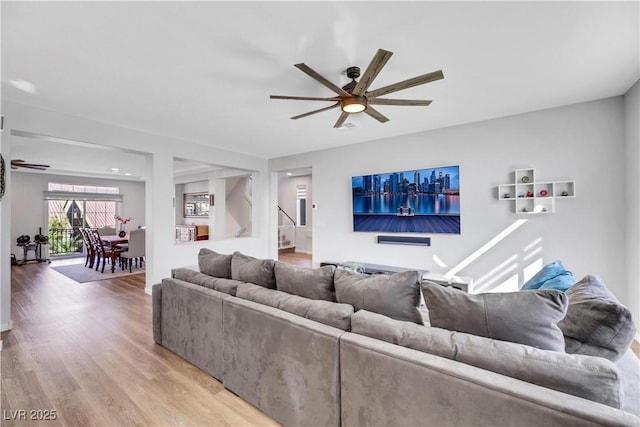 living room with hardwood / wood-style floors and ceiling fan