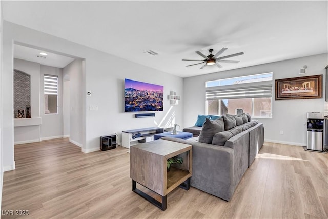 living room featuring ceiling fan and light wood-type flooring