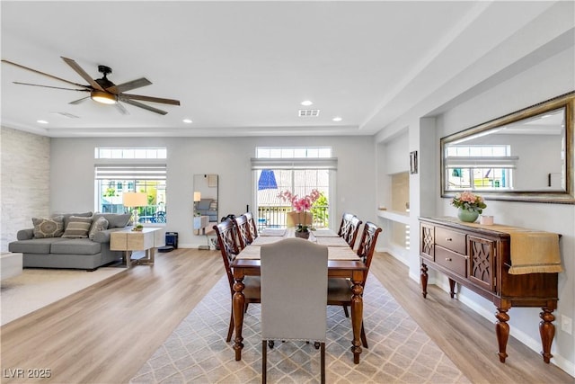 dining space featuring hardwood / wood-style floors, a healthy amount of sunlight, and ceiling fan