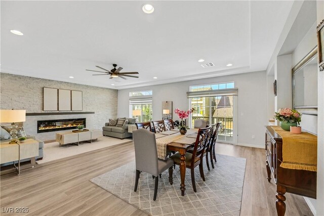 dining room with ceiling fan and light wood-type flooring