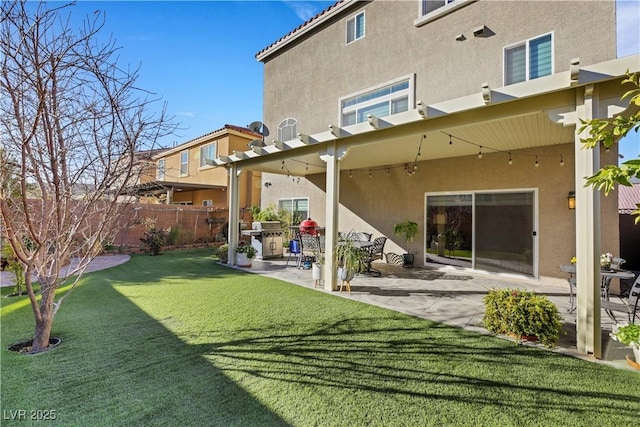 back of house featuring a patio and a lawn