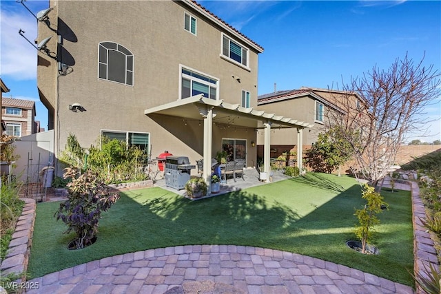 rear view of house with a pergola, a patio area, and a lawn