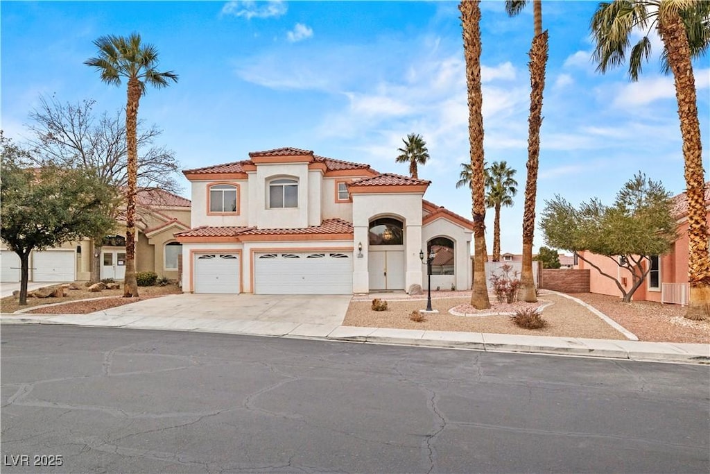 mediterranean / spanish-style home with a garage