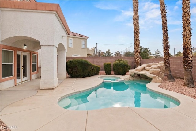 view of swimming pool with french doors, an in ground hot tub, and a patio