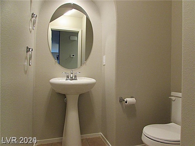 bathroom featuring tile patterned floors and toilet