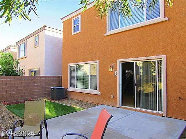 rear view of property featuring cooling unit and a patio