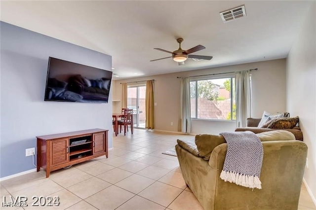 tiled living room with ceiling fan