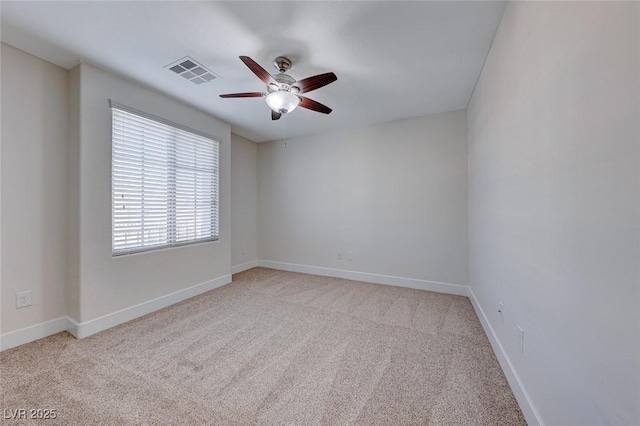 spare room with light colored carpet and ceiling fan