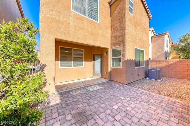 rear view of property featuring central AC and a patio