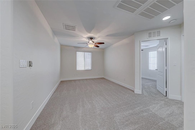 unfurnished room with light carpet, ceiling fan, and a healthy amount of sunlight