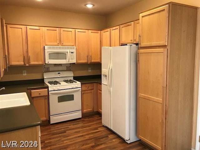 kitchen with dark hardwood / wood-style flooring, sink, light brown cabinetry, and white appliances