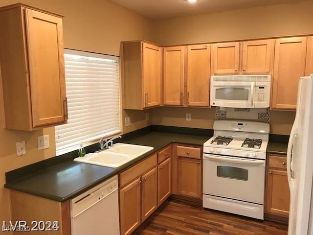 kitchen featuring sink, white appliances, and dark wood-type flooring