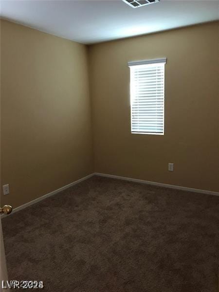 empty room with dark carpet