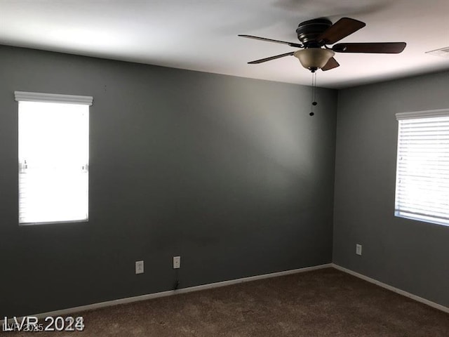 carpeted spare room featuring ceiling fan